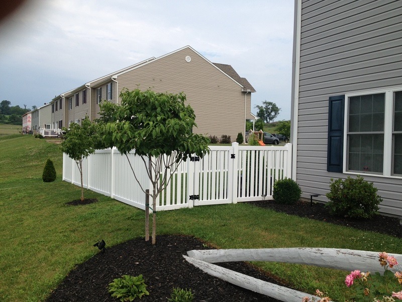 White vinyl fencing with trees