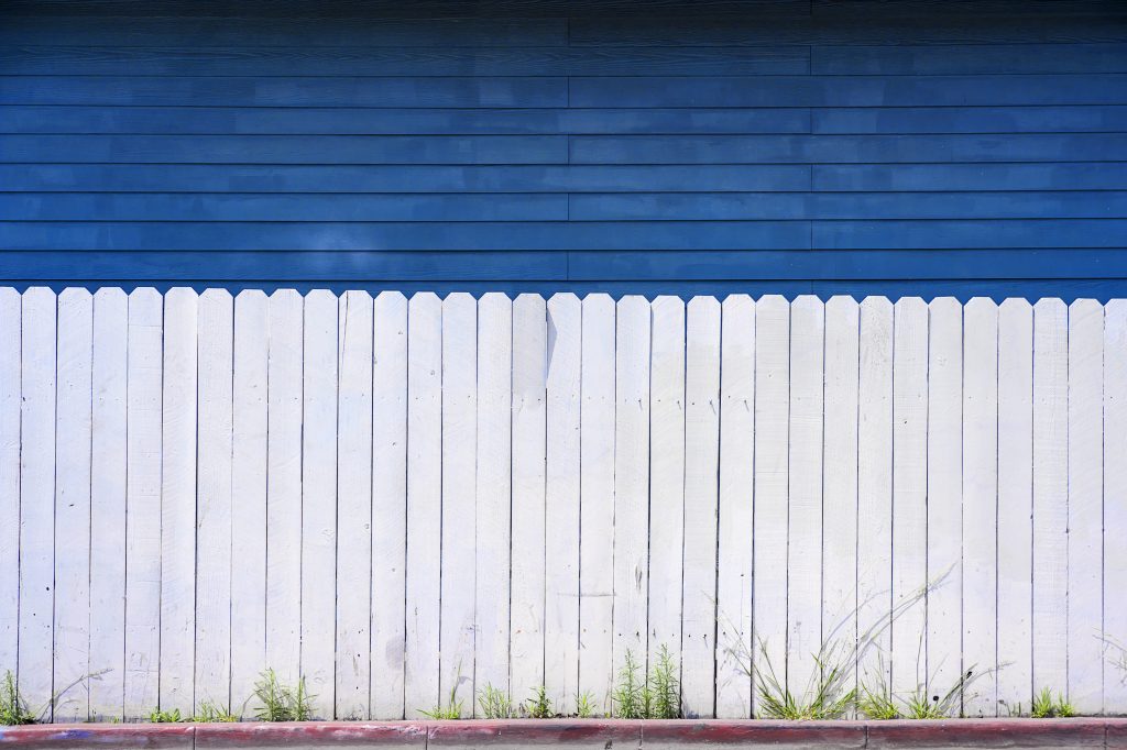 White fence and blue house